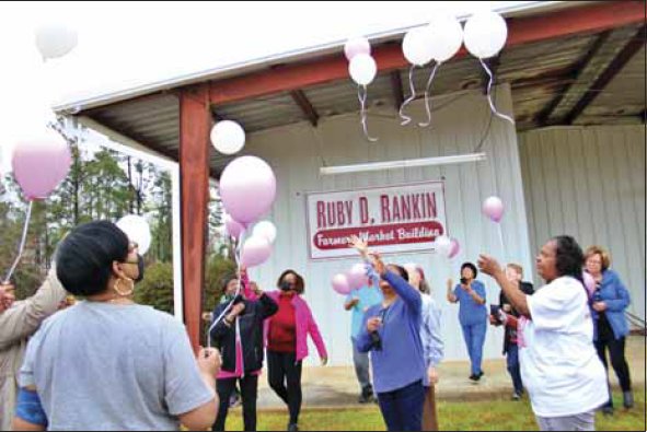 Members of the Kemper County Homemaker Volunteers and the Ruby Jewels gathered at the Ruby D. Rankin Farmers
Market Building in DeKalb to honor the building's namesake, Ruby D. Rankin. They are preparing for the balloon release
in honor of Rankin.